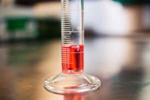 Red diesel fuel in a graduated cylinder