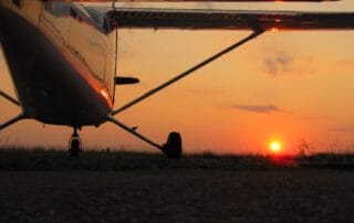 aircraft landing at sunset