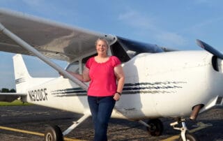 Amanda standing in front of an airplane