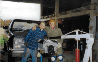 Happy Jim and Ryan posing behind the engine from the '84 Chevy.