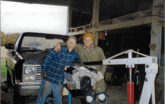 Happy Jim and Ryan posing behind the engine from the '84 Chevy.