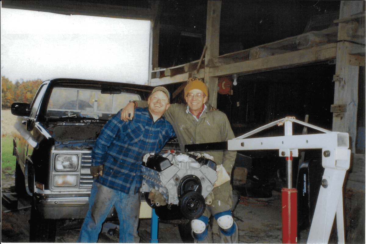 Happy Jim and Ryan posing behind the engine from the '84 Chevy.