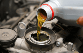 oil pouring form a bottle into an engine