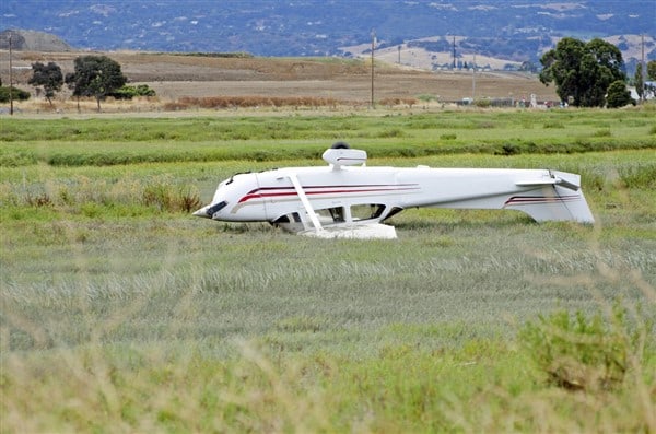 upside down airplane in a field