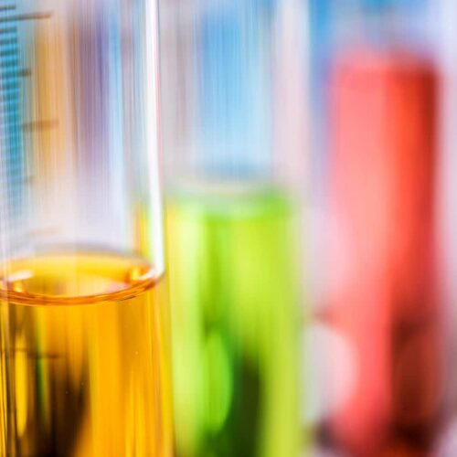 Oil, coolant, and fuel samples in test tubes for analysis