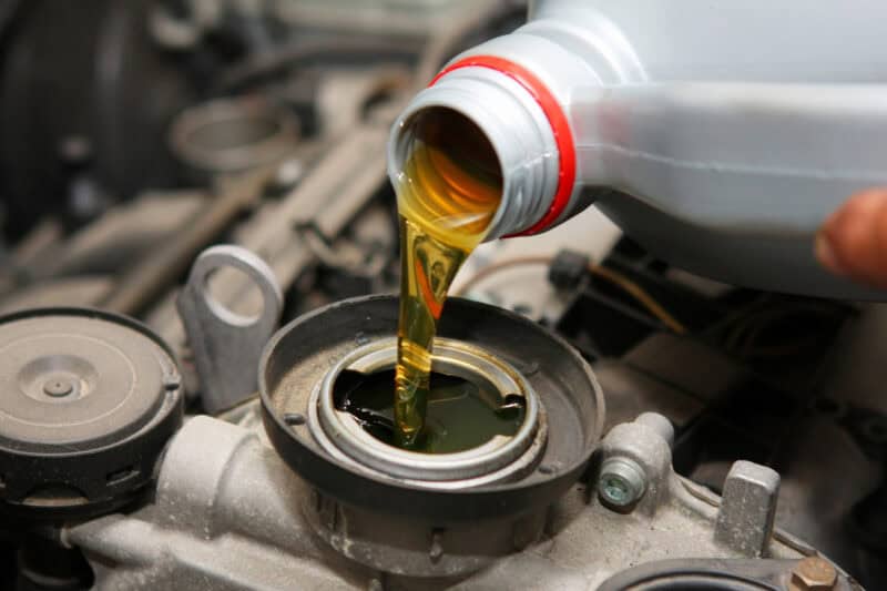 oil pouring from bottle into engine