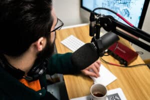 Blackstone Joe recording the latest Slick Talk podcast next to a mic and a cup of coffee