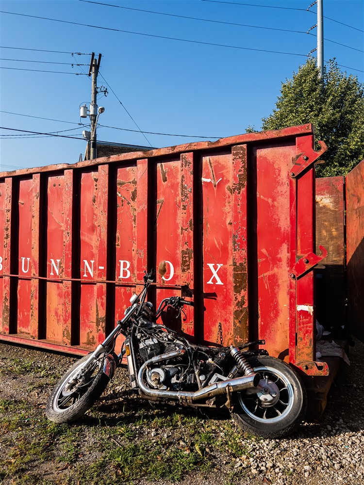 old motorcycle leaning against a Bunn Box