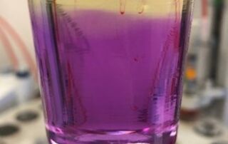 Aeroshell 100 Mineral oil - bright purple with titration solution added