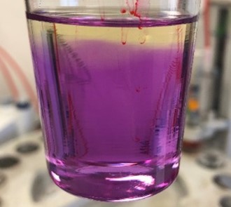 Aeroshell 100 Mineral oil - bright purple with titration solution added